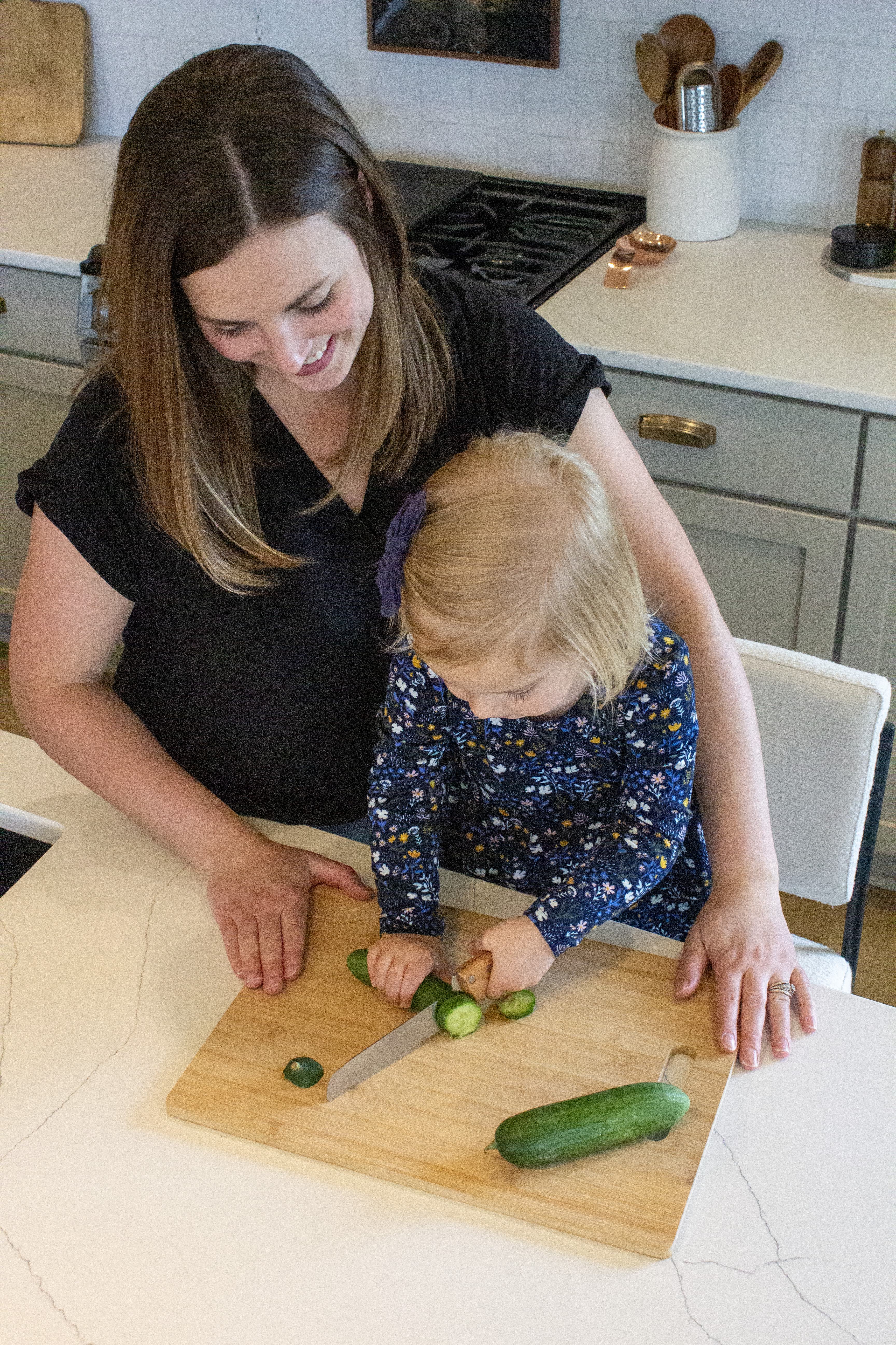 Mom and daughter enjoying cooking healthy meals in the kitchen. 